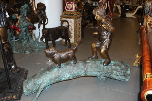 Kid with dog walking on a log Bronze Statue -  Size: 57"L x 18"W x 41"H.