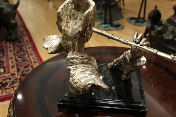 Man playing Flute Bronze Statue -  Size: 10"L x 8"W x 10"H.