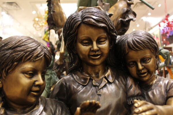 Three Children On Log Holding Bird Bronze Statue -  Size: 55"L x 18"W x 38"H.