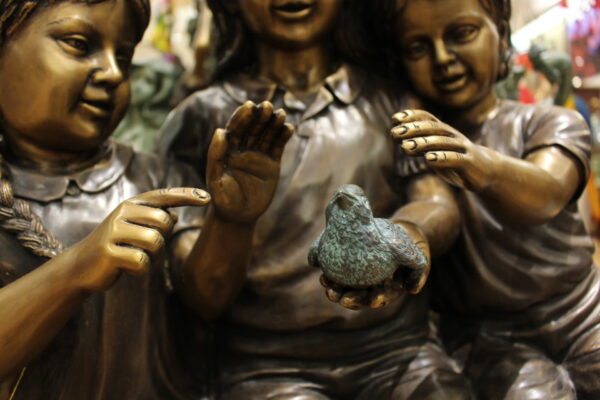 Three Children On Log Holding Bird Bronze Statue -  Size: 55"L x 18"W x 38"H.