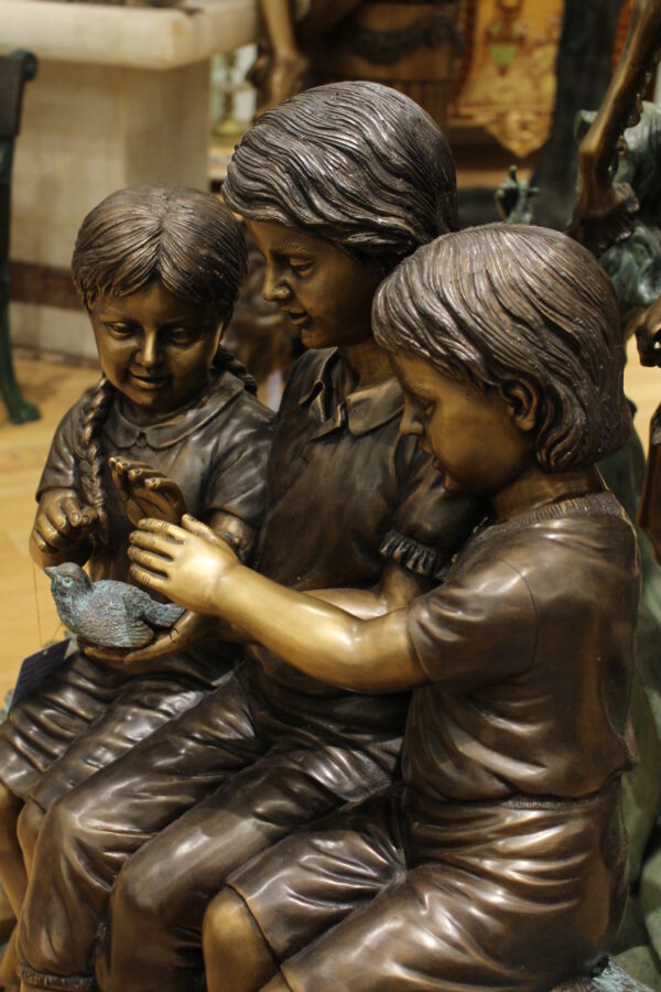 Three Children On Log Holding Bird Bronze Statue -  Size: 55"L x 18"W x 38"H.