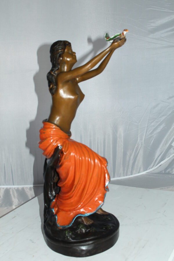 Lady Holds a Bird Up Bronze Statue -  Size: 7"L x 7"W x 20"H.