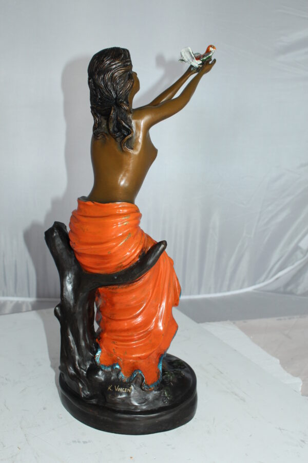 Lady Holds a Bird Up Bronze Statue -  Size: 7"L x 7"W x 20"H.