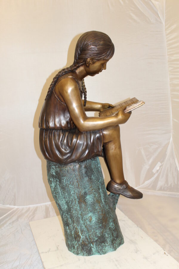 Girl Sitting on a Tree Stump Reading a Book Bronze Statue -  15"L x 17"W x 38"H