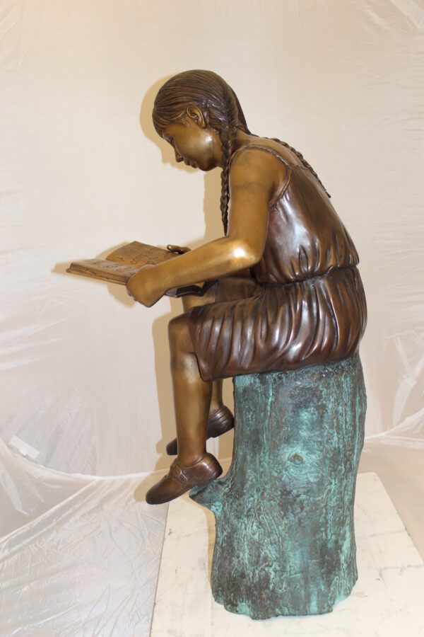 Girl Sitting on a Tree Stump Reading a Book Bronze Statue -  15"L x 17"W x 38"H