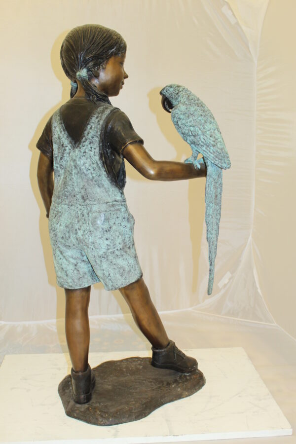 Girl Holding a Parrot Bronze Statue -  Size: 26"L x 19"W x 42"H.