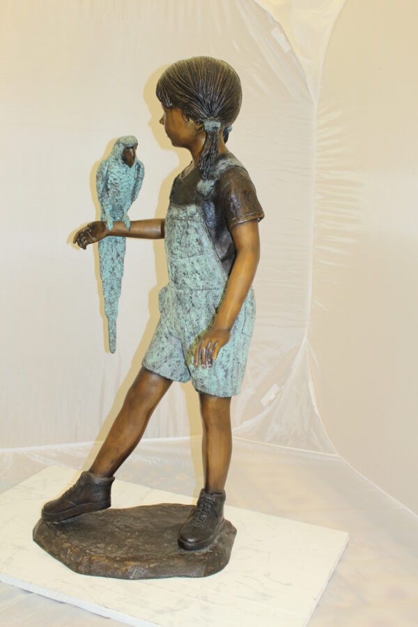 Girl Holding a Parrot Bronze Statue -  Size: 26"L x 19"W x 42"H.