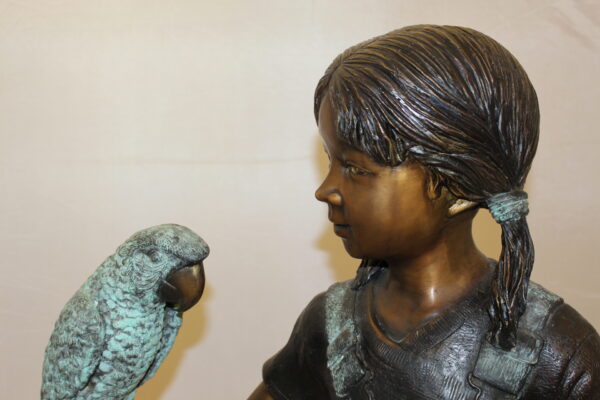 Girl Holding a Parrot Bronze Statue -  Size: 26"L x 19"W x 42"H.