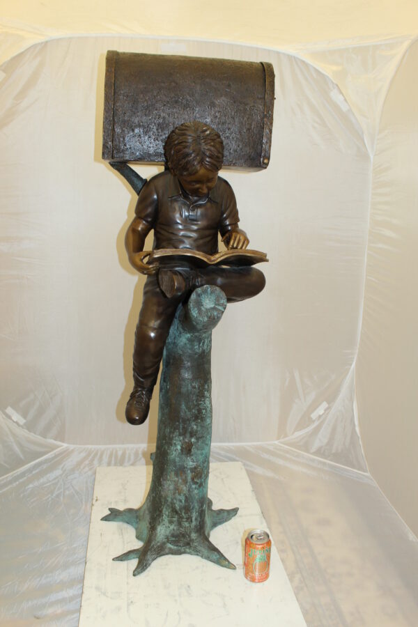 Boy Sitting by a Mailbox reading a book Bronze Statue -  16"L x 20"W x 50"H.