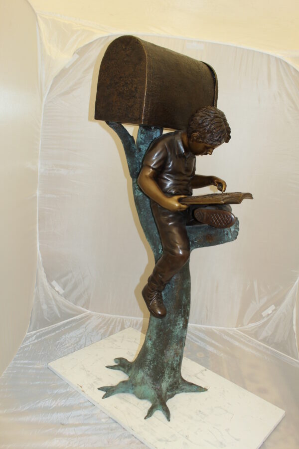 Boy Sitting by a Mailbox reading a book Bronze Statue -  16"L x 20"W x 50"H.