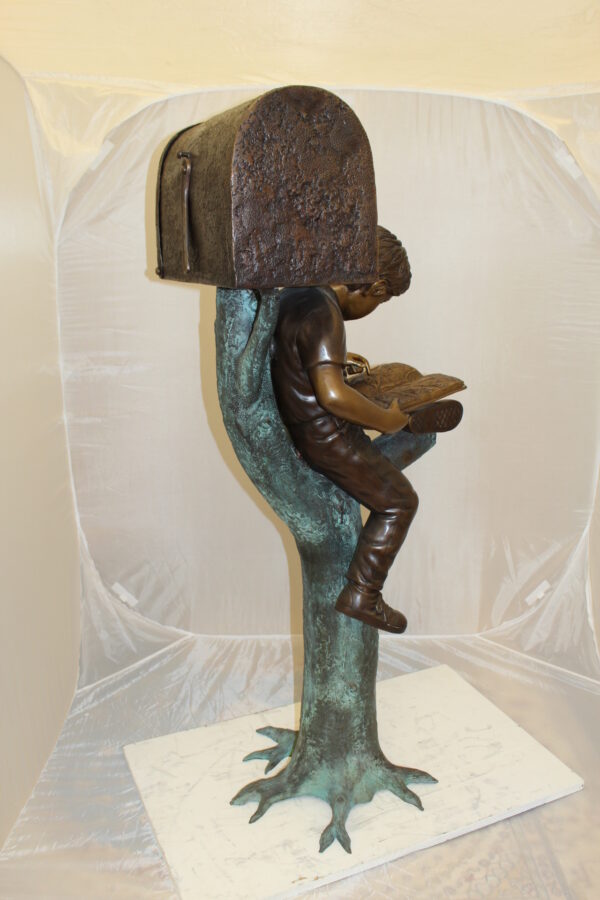 Boy Sitting by a Mailbox reading a book Bronze Statue -  16"L x 20"W x 50"H.