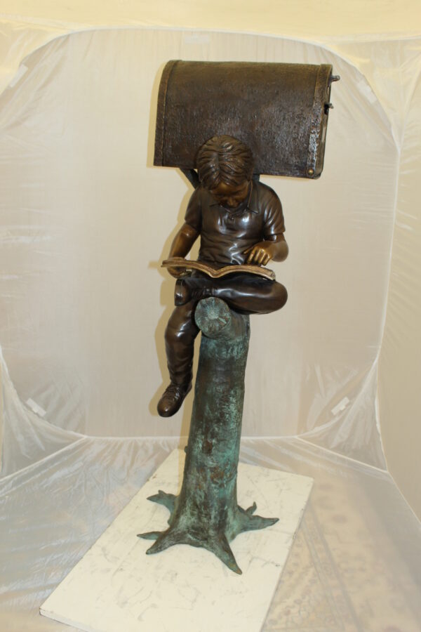 Boy Sitting by a Mailbox reading a book Bronze Statue -  16"L x 20"W x 50"H.