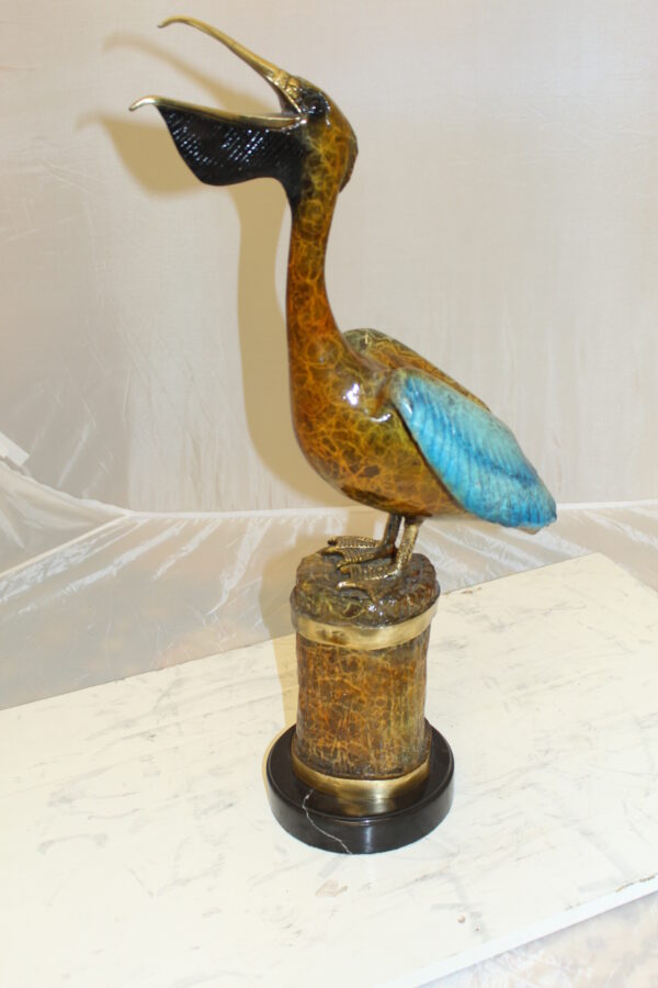 Pelican on a Tree Stump Bronze Statue -  Size: 8"L x 12"W x 27"H.
