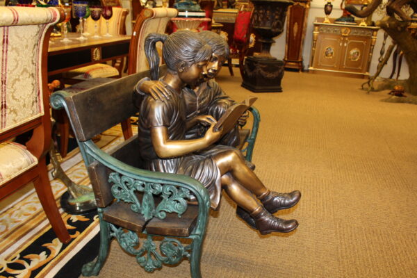 Kids Reading a Book on a Bench Bronze Statue -  Size: 23"L x 38"W x 37"H.