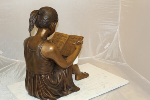 Girl Sitting and Reading a Book Bronze Statue -  Size: 23"L x 15"W x 24"H.