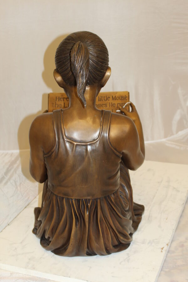 Girl Sitting and Reading a Book Bronze Statue -  Size: 23"L x 15"W x 24"H.