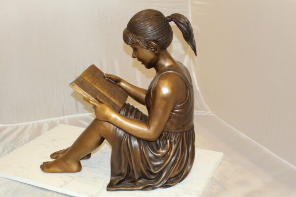 Girl Sitting and Reading a Book Bronze Statue -  Size: 23"L x 15"W x 24"H.