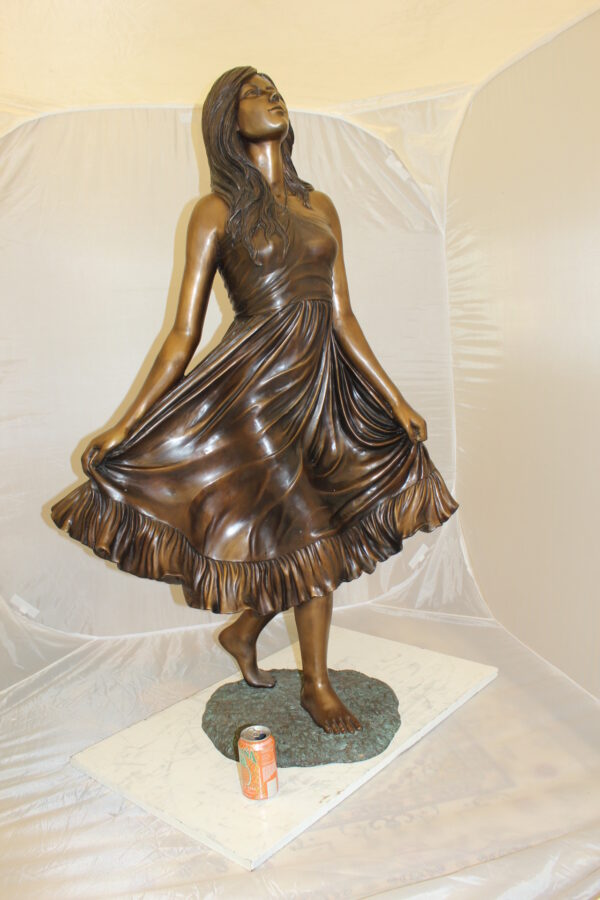 Lady holding her Skirt Bronze Statue -  Size: 32"L x 17"W x 53"H.