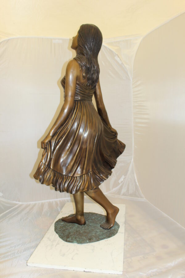 Lady holding her Skirt Bronze Statue -  Size: 32"L x 17"W x 53"H.