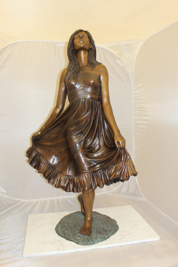 Lady holding her Skirt Bronze Statue -  Size: 32"L x 17"W x 53"H.