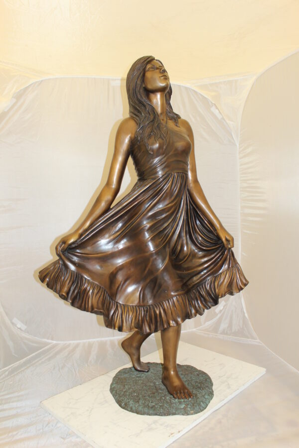 Lady holding her Skirt Bronze Statue -  Size: 32"L x 17"W x 53"H.