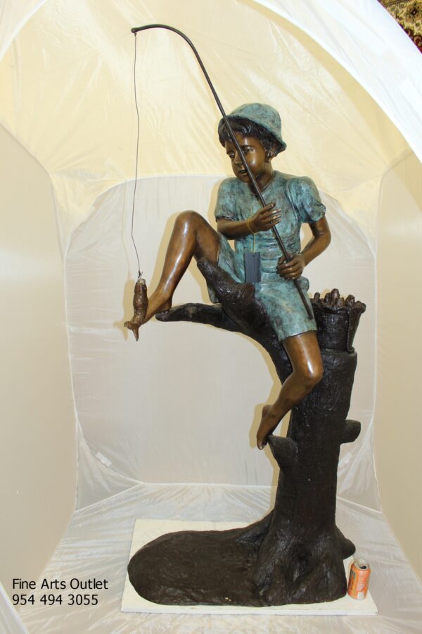 Boy Sitting on a Tree and Fishing Bronze Statue -  Size: 36"L x 21"W x 37"H.