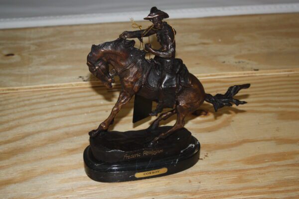 Remington Cowboy on marble Bronze Statue -  Size: 10"L x 3.5"W x 10"H.
