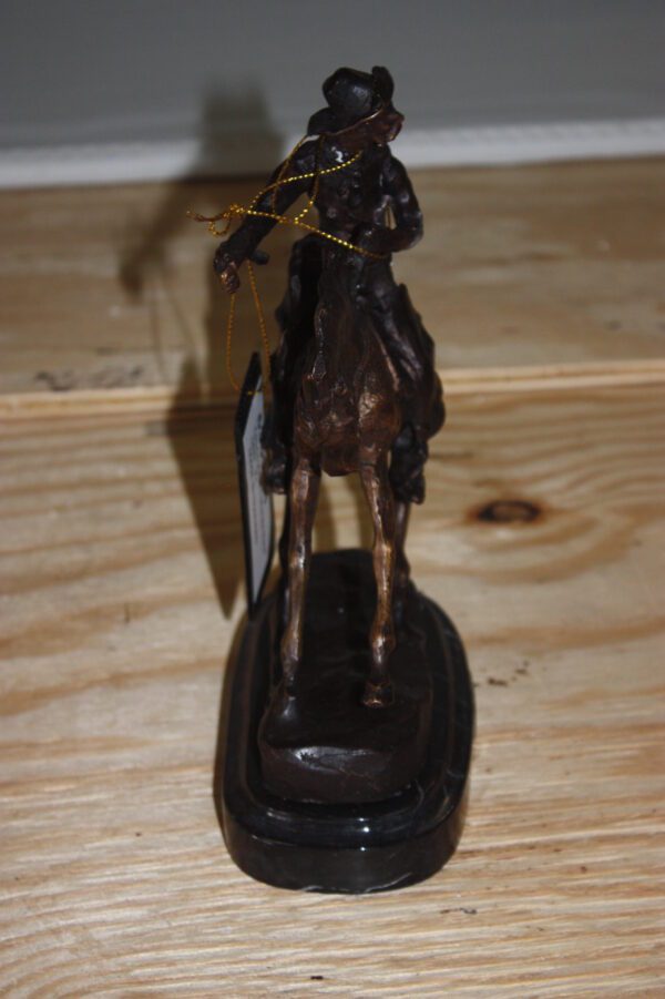 Remington Cowboy on marble Bronze Statue -  Size: 10"L x 3.5"W x 10"H.