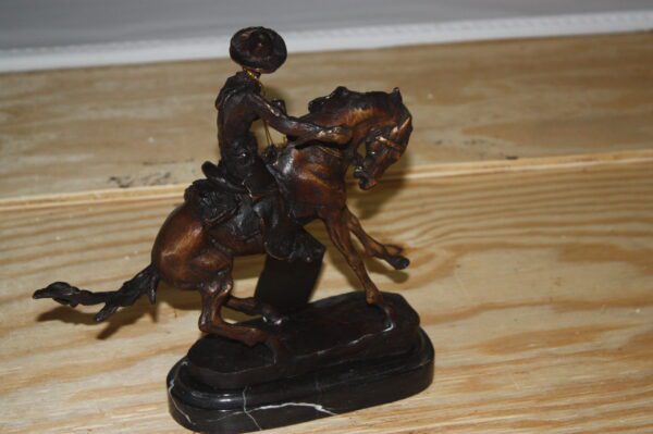 Remington Cowboy on marble Bronze Statue -  Size: 10"L x 3.5"W x 10"H.