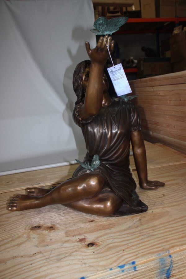 Girl with butterflies  - Bronze Statue -  Size: 27"L x 17"W x 24"H.