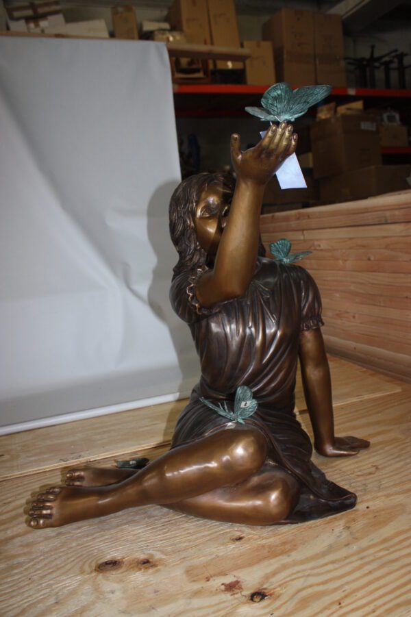 Girl with butterflies  - Bronze Statue -  Size: 27"L x 17"W x 24"H.