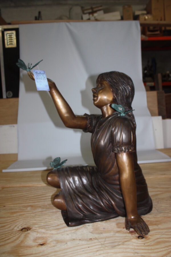 Girl with butterflies  - Bronze Statue -  Size: 27"L x 17"W x 24"H.