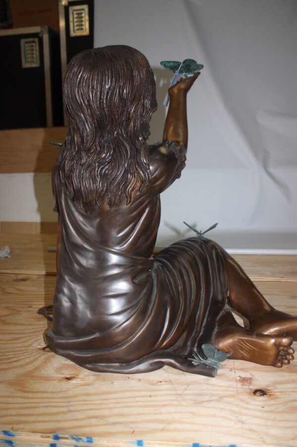 Girl with butterflies  - Bronze Statue -  Size: 27"L x 17"W x 24"H.