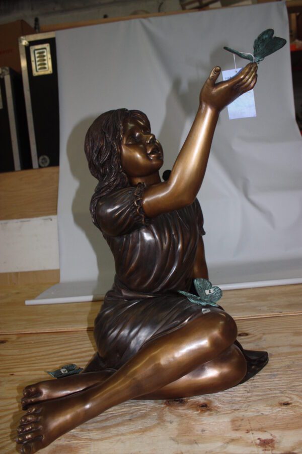 Girl with butterflies  - Bronze Statue -  Size: 27"L x 17"W x 24"H.