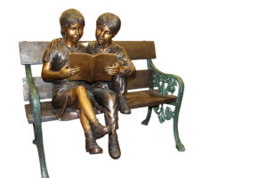 Kids Reading a Book on a Bench Bronze Statue -  Size: 23"L x 38"W x 37"H.