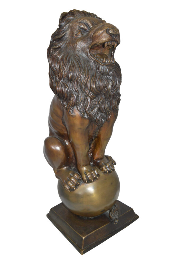 Pair of lions standing on balls, bronze statues -  Size: 14"L x 16"W x 38"H.