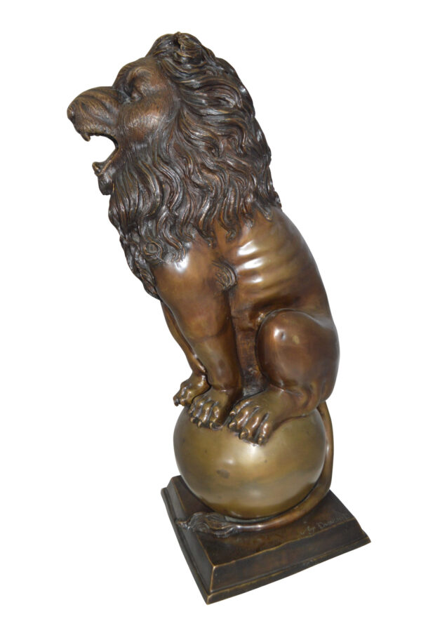 Pair of lions standing on balls, bronze statues -  Size: 14"L x 16"W x 38"H.