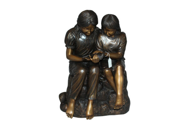 Two kids holding a bird Bronze Statue -  Size: 18"L x 26"W x 34"H.