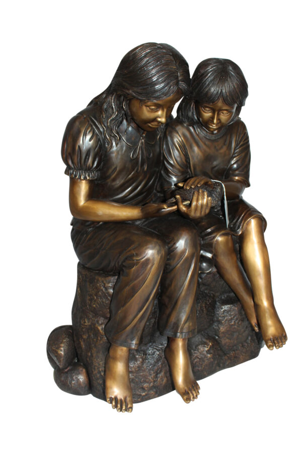 Two kids holding a bird Bronze Statue -  Size: 18"L x 26"W x 34"H.