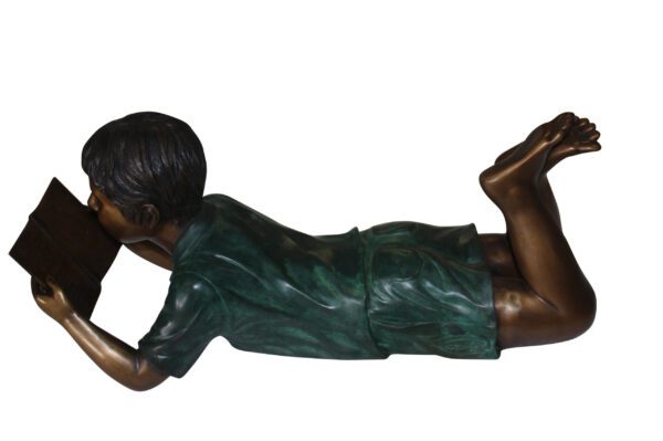 boy laying reading book bronze Statue -  Size: 24"L x 10"W x 11"H.