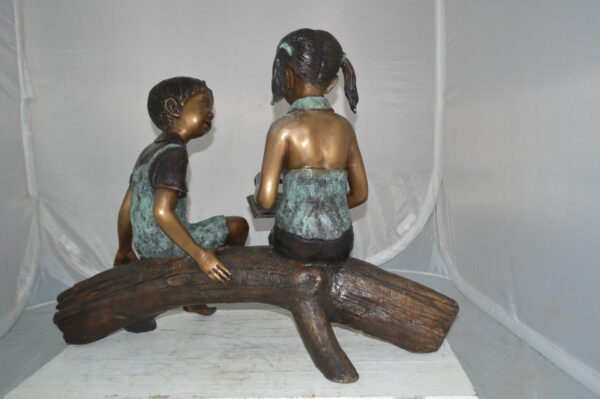 Boy and Girl on a tree log reading Bronze Statue -  Size: 37"L x 14"W x 27"H. - Image 9