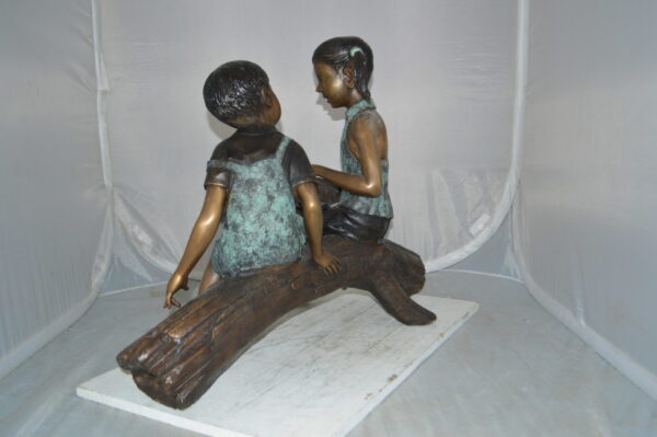 Boy and Girl on a tree log reading Bronze Statue -  Size: 37"L x 14"W x 27"H. - Image 10