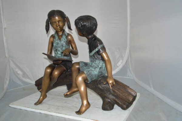 Boy and Girl on a tree log reading Bronze Statue -  Size: 37"L x 14"W x 27"H. - Image 12
