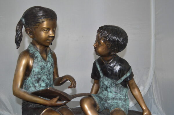 Boy and Girl on a tree log reading Bronze Statue -  Size: 37"L x 14"W x 27"H. - Image 13
