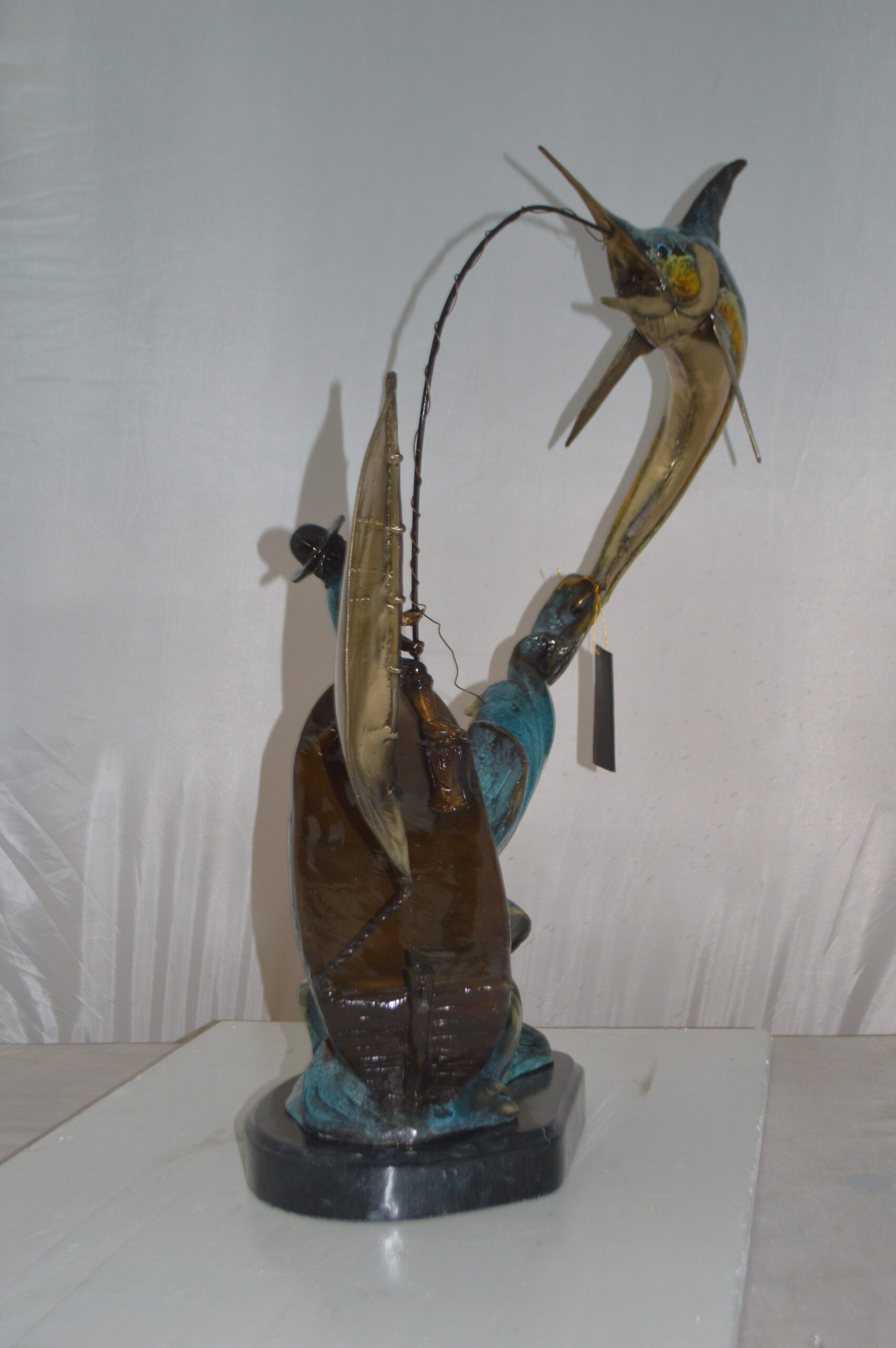 Old Man Fishing A Large Catch Bronze Statue - Size: 27 inchl x 13 inchw x 30 inchh.