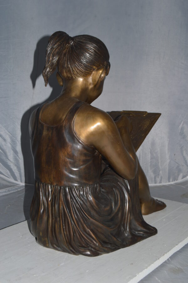 Girl reading from a notebook Bronze Statue -  Size: 26"L x 16"W x 25"H. - Image 7