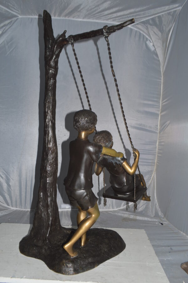 Kids Playing on a Swing bronze Statue -  Size: 22"L x 25"W x 43"H. - Image 7
