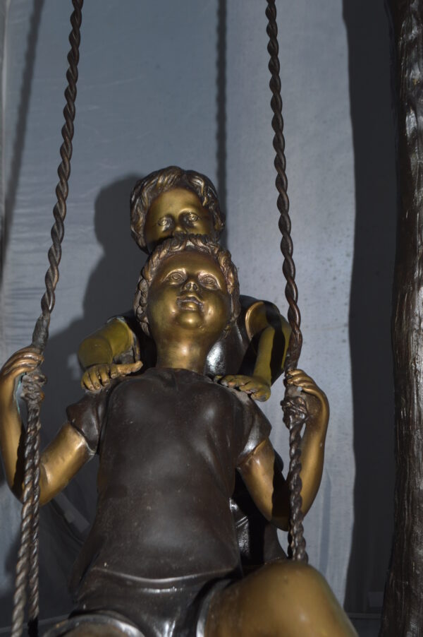 Kids Playing on a Swing bronze Statue -  Size: 22"L x 25"W x 43"H. - Image 9