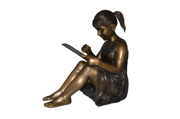 Girl reading from a notebook Bronze Statue -  Size: 26"L x 16"W x 25"H.