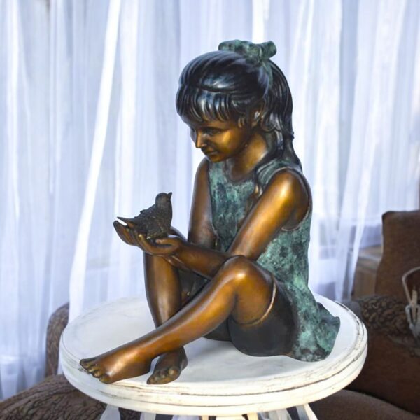 Girl Knees Up Holding a Bird Bronze Statue -  Size: 22"L x 14"W x 24"H. - Image 2